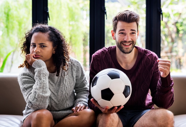 Couple watching a football game