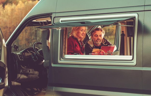 Photo couple watching movie online inside their camper van