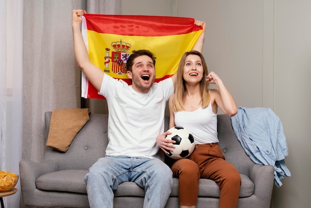 Photo couple watching sport program at tv