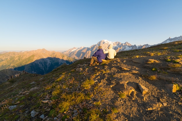 Couple watching sunrise over Mont Blanc summit