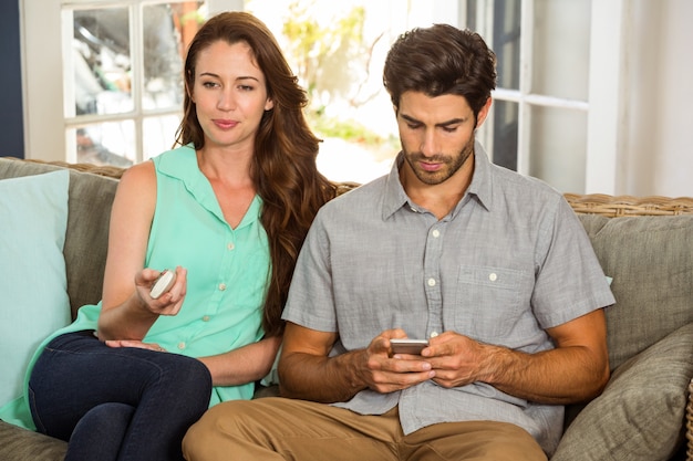 Couple watching television in living room