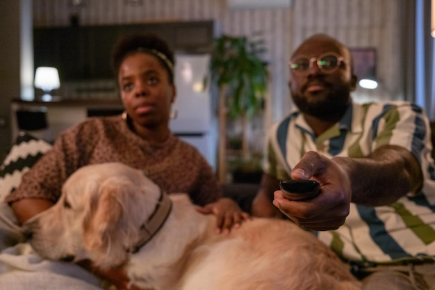 Couple watching tv at home