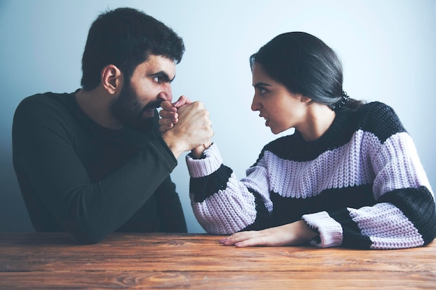 Couple wearing suit fighting looking each other