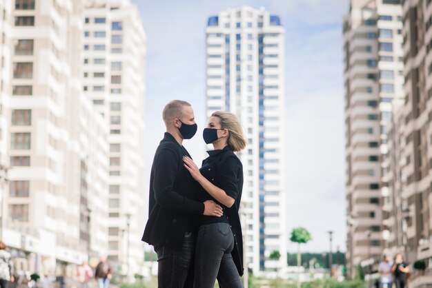 Couple wearing trendy fashionable protective masks