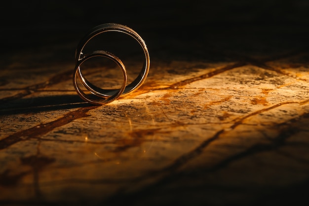 Couple wedding rings on old marble texture