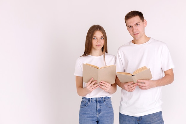 Couple in white T-shirts reads a book