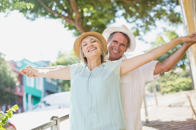 Couple with arms outstretched