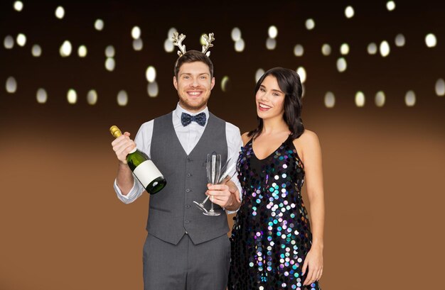 couple with champagne bottle at christmas party