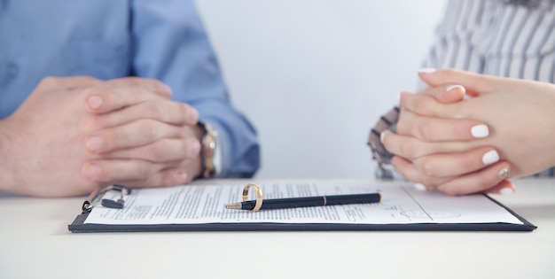 Couple with divorce contract and ring. Divorce