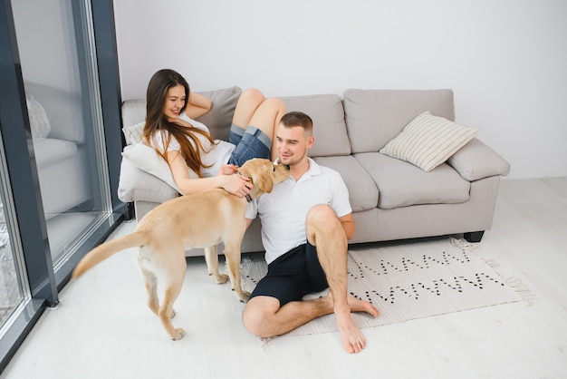 Couple with dog sitting at home