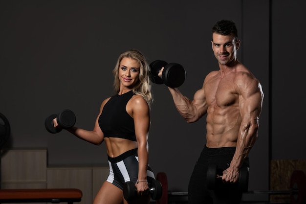 Couple With Dumbbell Exercising Biceps