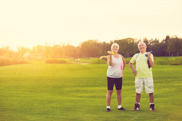 Photo couple with dumbbells smiling