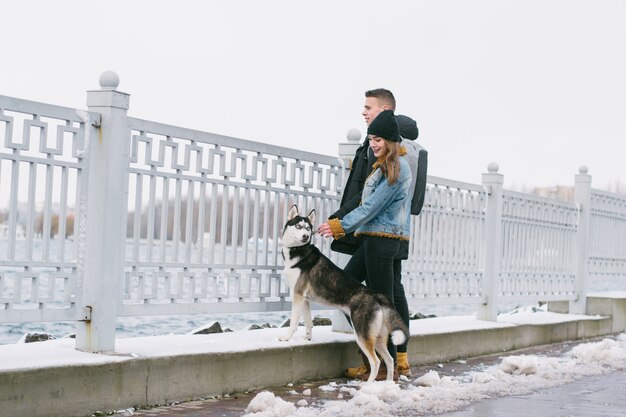 couple with huskies