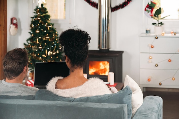 Couple with laptop in cozy room