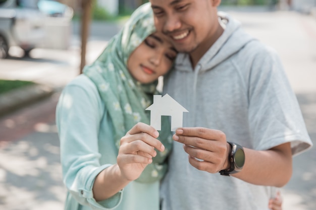 Couple with paper of house