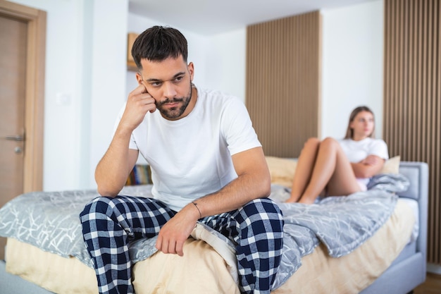 Couple With Problems Having Disagreement In Bed Frustrated couple arguing and having marriage problems Young couple into an argument on bed in bedroom