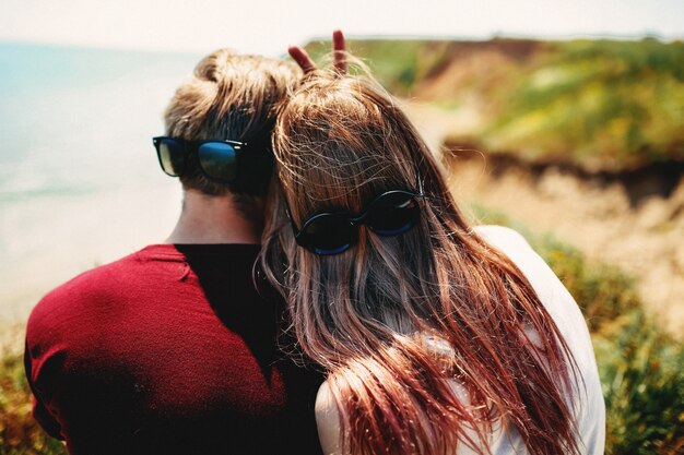 Couple with sunglasses on the neck