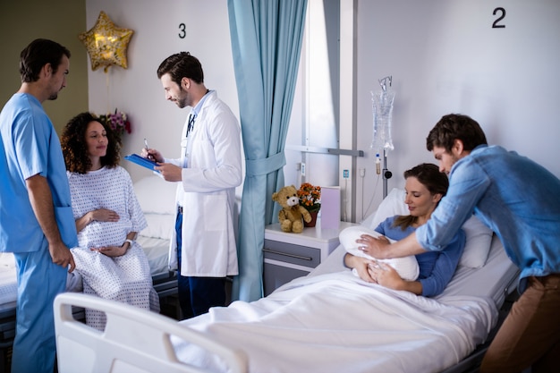 Couple with their newborn baby in the ward