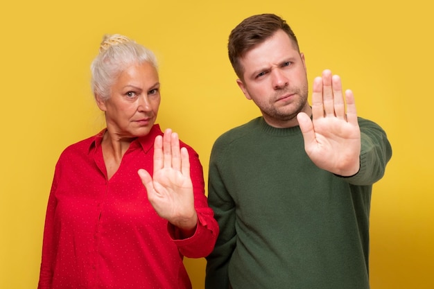 Couple woman and man mother ans son showing refusal gesture