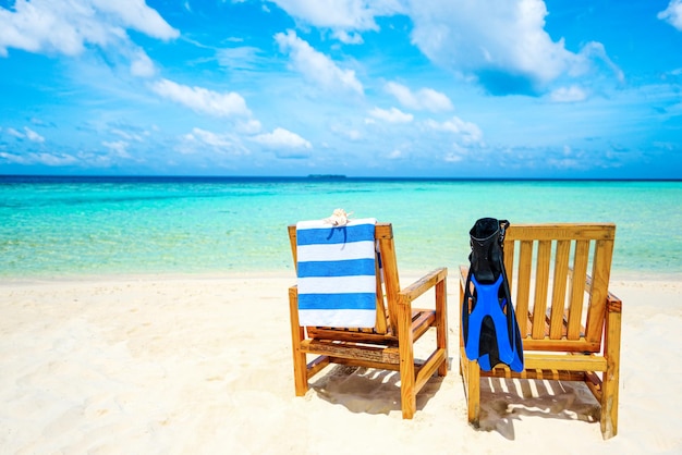 Couple of wooden chair standing on a beach Indian Ocean