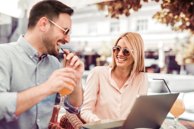 Couple working on laptop in cafe