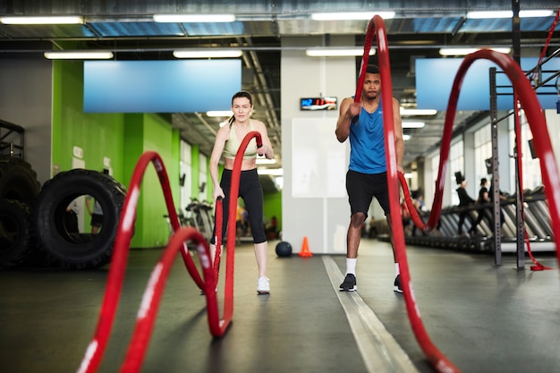 Couple Working Out with Battle Ropes