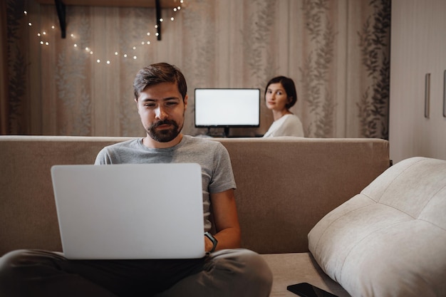 Couple Working And Playing With Laptop Computer At Home