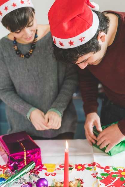  couple wrapping christmas presents