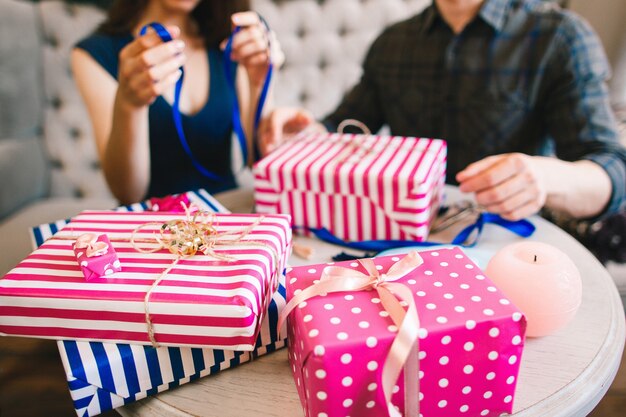 Photo couple wrapping gifts for family and friends.