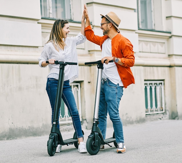 Couple young electric scooter city transport riding technology lifestylestreet friend driving modern