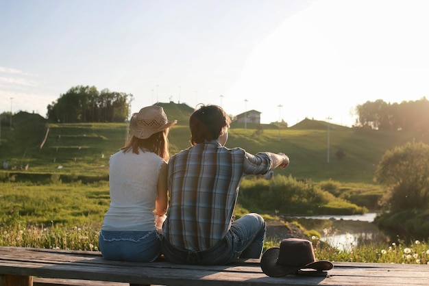 Couple of young people admire the sunset in the spring evening