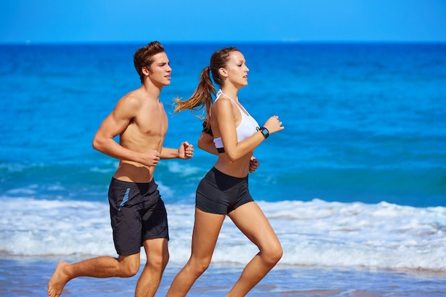 Couple young running in the beach in summer