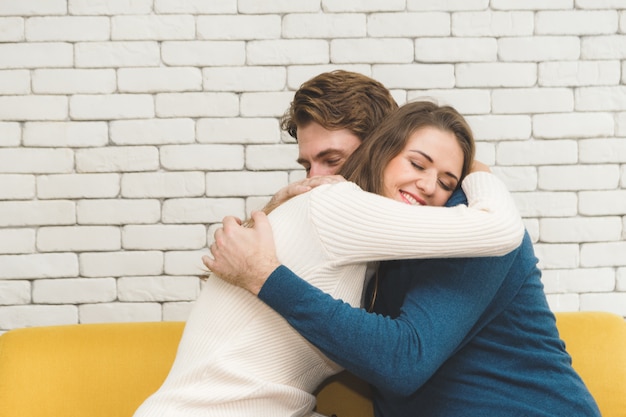 Couples happily hugging each other.