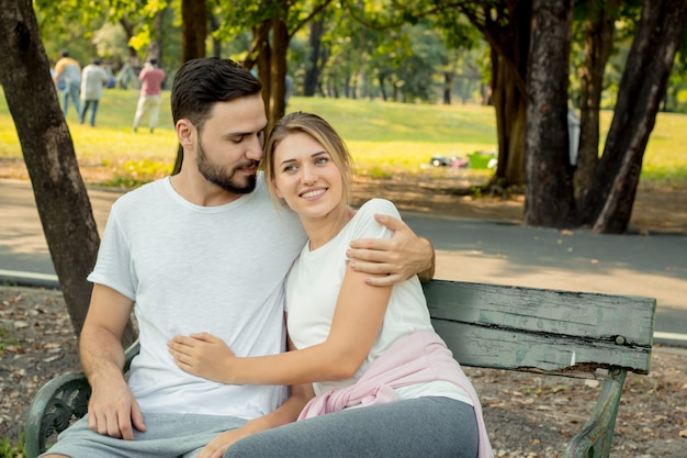 Couples sitting and hugging in the park.