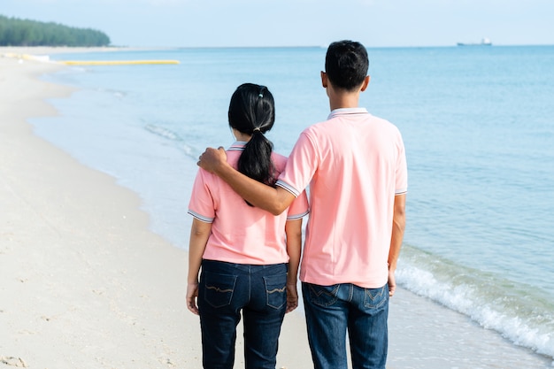 Couples walking on the beach on a summer vacation