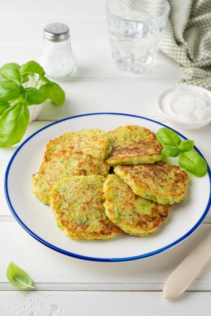 Courgette beignets met kaas knoflook en kruiden Vegetarische courgette pannenkoeken met zure room