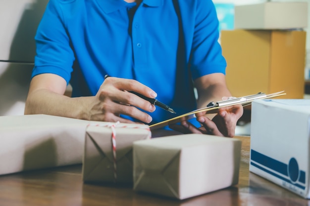 Courier checking the delivery receipt list in office.