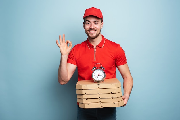 Courier delivering boxes with pizza