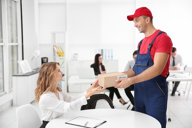 courier delivering package in office