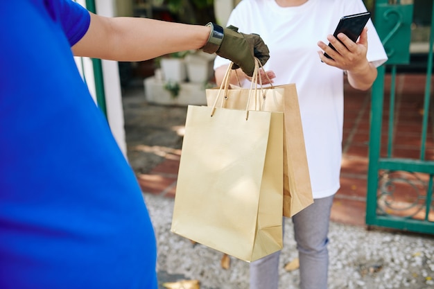 Courier delivering paper-bags