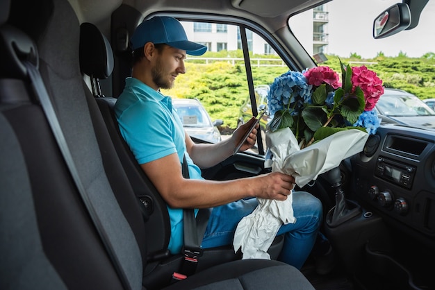 Courier inside the white van during flowers delivery