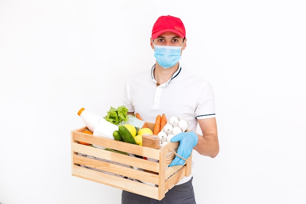 Courier's hands in latex white medical gloves deliver parcels in brown cardboard boxes to the door during the epidemic of coronovirus,COVID-19. Safe delivery of online orders during the epidemic.