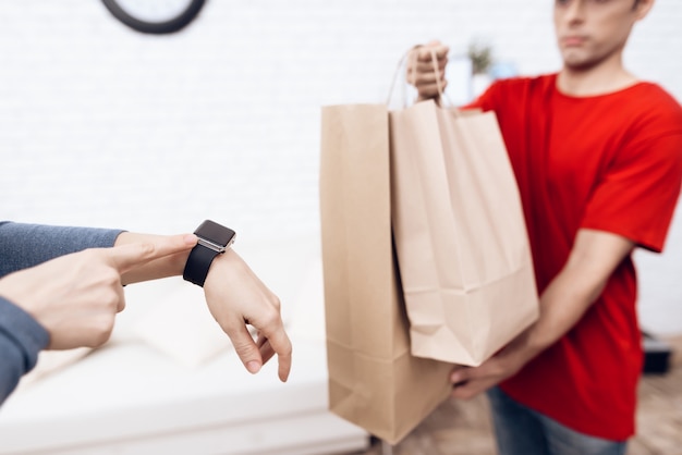 Courier with Packages and Woman with Clock on Arm.