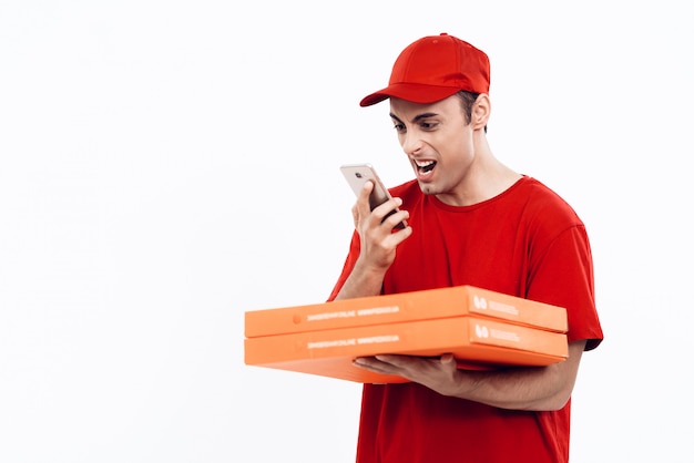 Courier with Pizza in Uniform Shouts into Phone.