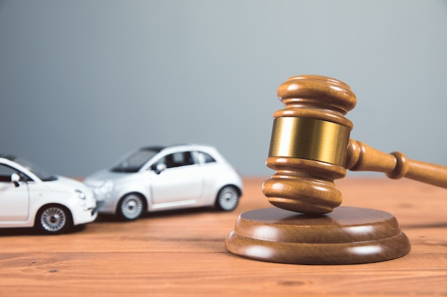 Court gavel with toy cars on the table accident