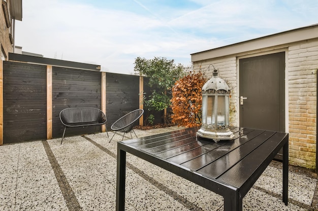 Courtyard of the house with black comfortable chairs