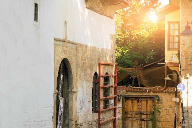 Courtyard with old buildings wooden gate and wicker figure of man