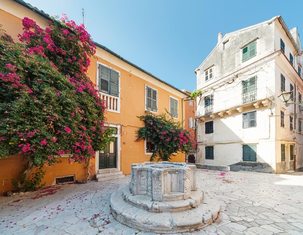 Courtyard with venetian well in the Old town of Corfu, Greece