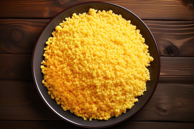 Couscous cornmeal porridge in a bowl on a wooden background