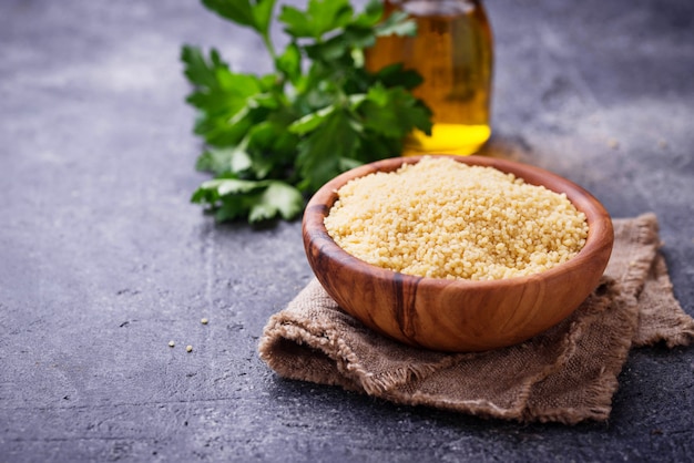 Couscous grain in wooden bowl 